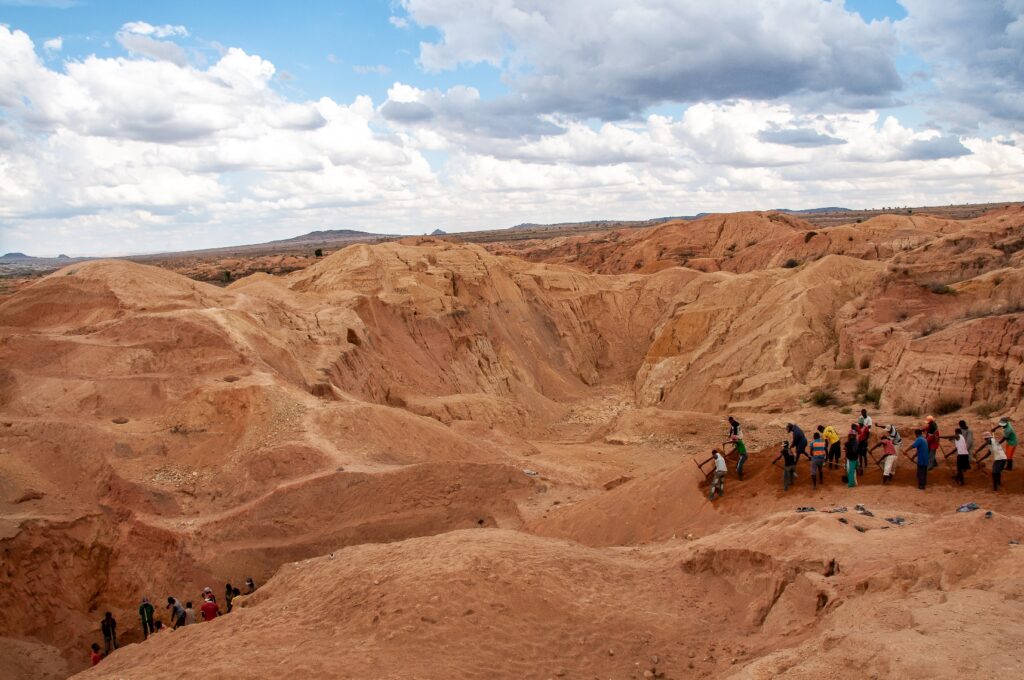 Teams of workers dig and move huge quantities of sand in search of Gem stones